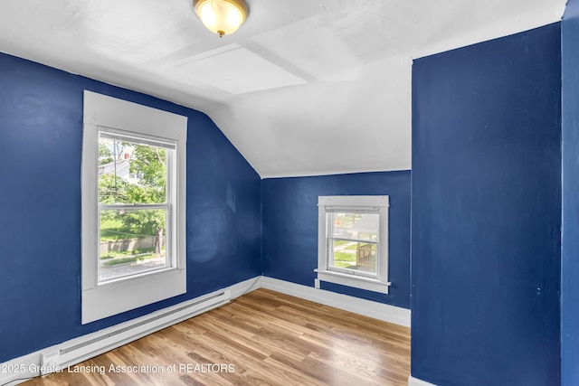 922 Dakin St, Lansing, MI 48912 - additional living space featuring a baseboard radiator, vaulted ceiling, wood finished floors, and baseboards