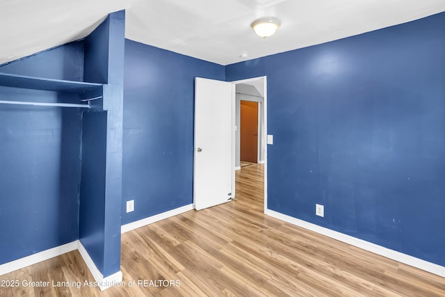922 Dakin St, Lansing, MI 48912 - unfurnished bedroom featuring baseboards, wood finished floors, and a closet