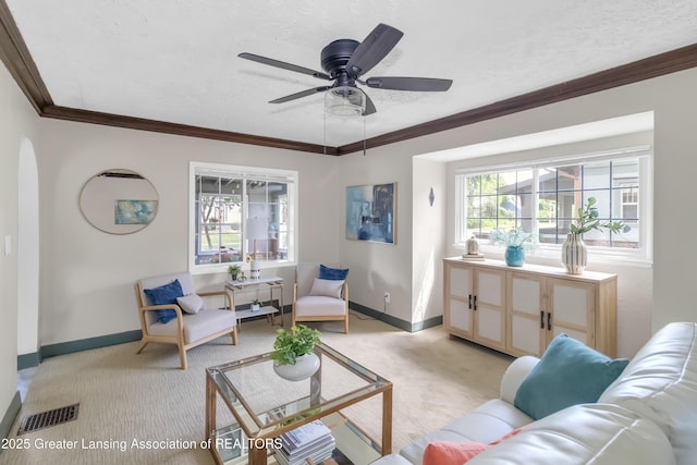 514 W St, Lansing, MI 48915 - living room with light carpet, baseboards, ornamental molding, and ceiling fan