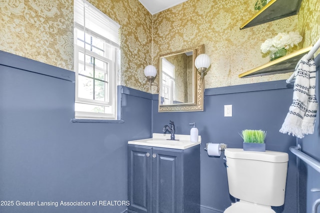 514 W St, Lansing, MI 48915 - bathroom featuring wallpapered walls, toilet, and vanity