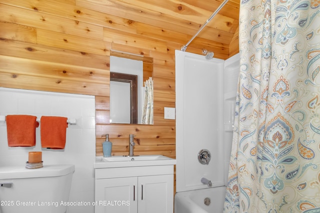 514 W St, Lansing, MI 48915 - full bath featuring vanity, toilet, shower / bath combination with curtain, and wooden walls
