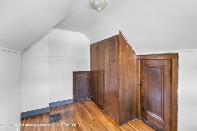 514 W St, Lansing, MI 48915 - additional living space with lofted ceiling and wood finished floors