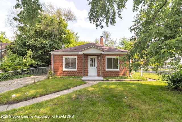 100 Dunlap St, Lansing, MI 48910 - view of front of property featuring brick siding and a chimney