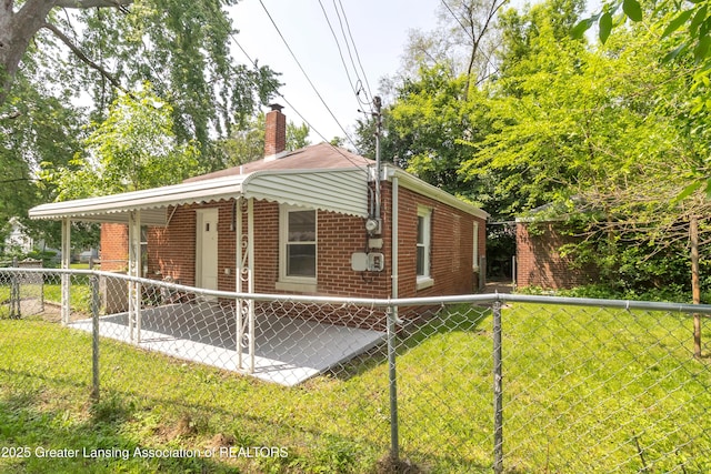 100 Dunlap St, Lansing, MI 48910 - view of home's exterior featuring brick siding and a chimney