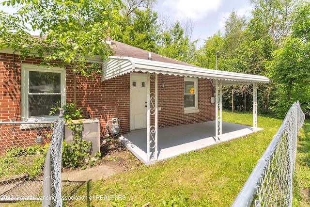100 Dunlap St, Lansing, MI 48910 - back of house with brick siding and a patio area