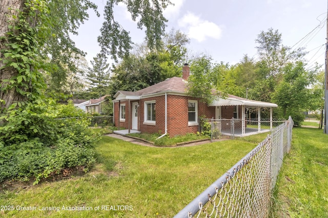 100 Dunlap St, Lansing, MI 48910 - view of front of house with brick siding and a chimney