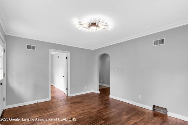 100 Dunlap St, Lansing, MI 48910 - empty room with arched walkways, ornamental molding, wood finished floors, and baseboards