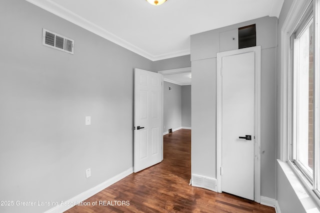 100 Dunlap St, Lansing, MI 48910 - unfurnished bedroom featuring baseboards, dark wood-type flooring, and ornamental molding