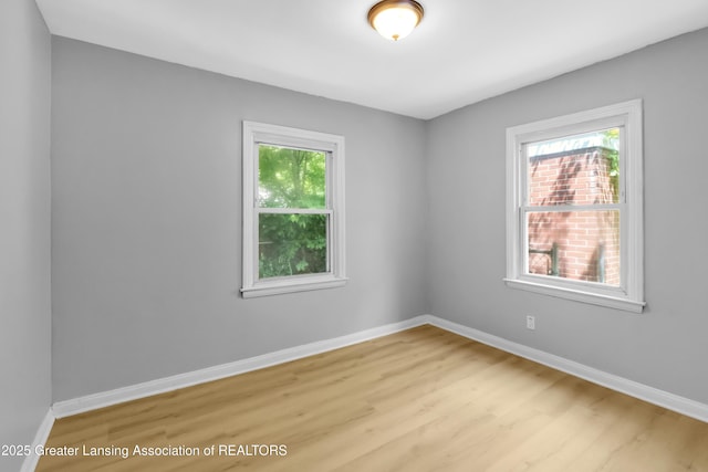 100 Dunlap St, Lansing, MI 48910 - unfurnished room featuring healthy amount of natural light, wood finished floors, and baseboards