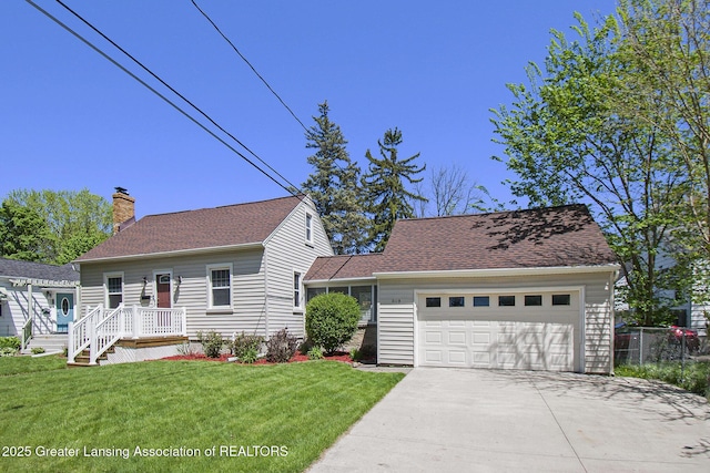2119 Grant St, Lansing, MI 48910 - view of front of home with concrete driveway, a chimney, a front yard, and a garage