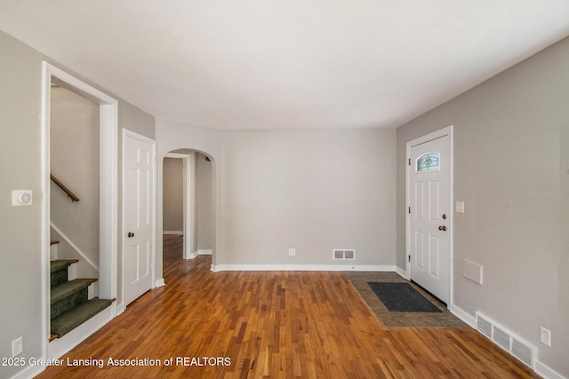 2119 Grant St, Lansing, MI 48910 - entryway with arched walkways, wood finished floors, stairs, and baseboards