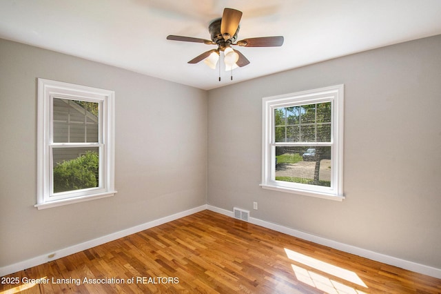 2119 Grant St, Lansing, MI 48910 - unfurnished room with wood finished floors, baseboards, and a ceiling fan