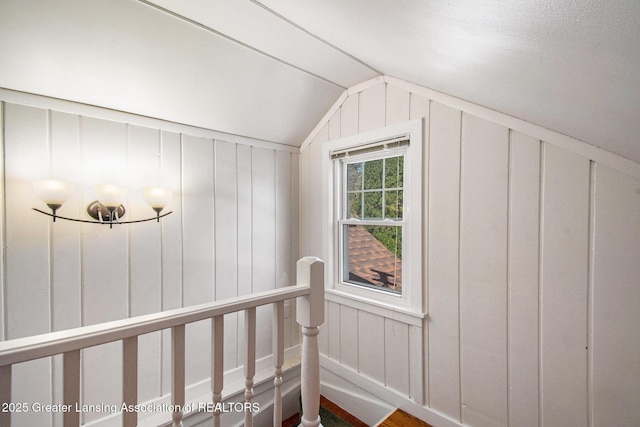 2119 Grant St, Lansing, MI 48910 - additional living space featuring vaulted ceiling, wood finished floors, and a decorative wall
