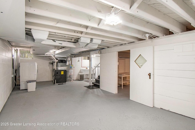 2119 Grant St, Lansing, MI 48910 - unfinished below grade area with water heater, heating unit, and stairs