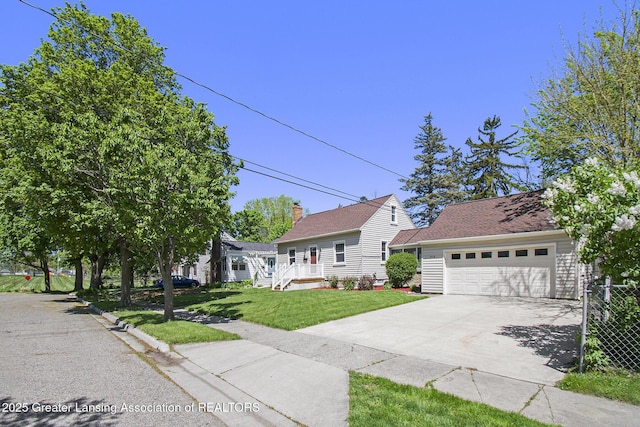 2119 Grant St, Lansing, MI 48910 - view of front facade featuring a front lawn, driveway, and an attached garage