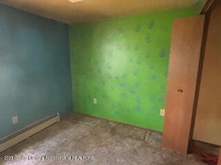 spare room featuring a baseboard radiator