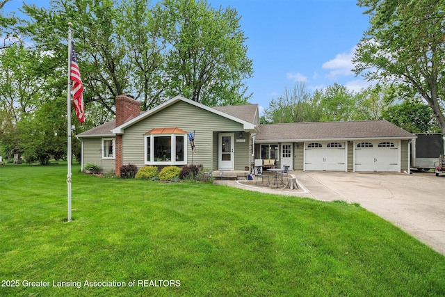 12197 W Greenfield Rd, Lansing, MI 48917 - view of front facade with an attached garage, driveway, a front yard, a chimney, and a shingled roof