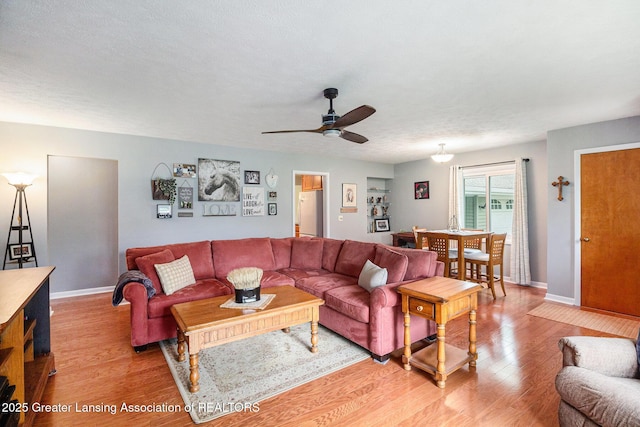 12197 W Greenfield Rd, Lansing, MI 48917 - living area featuring light wood-style flooring, a ceiling fan, and baseboards