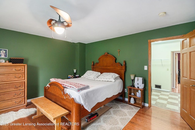 12197 W Greenfield Rd, Lansing, MI 48917 - bedroom with light wood-style floors, a ceiling fan, and baseboards