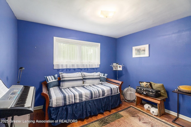 12197 W Greenfield Rd, Lansing, MI 48917 - bedroom featuring wood finished floors and baseboards