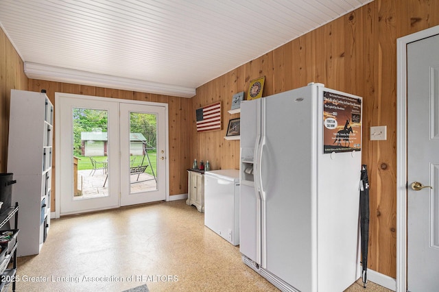12197 W Greenfield Rd, Lansing, MI 48917 - kitchen featuring white refrigerator with ice dispenser, wood walls, fridge, light flooring, and french doors
