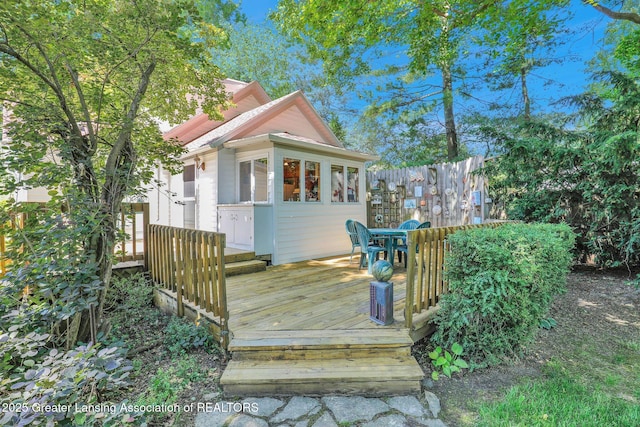 411 Jackson St, Grand Ledge, MI 48837 - deck with an outbuilding, outdoor dining area, and fence