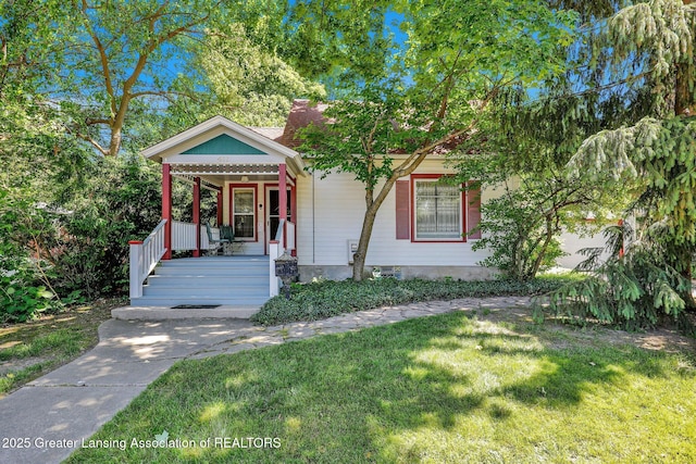 411 Jackson St, Grand Ledge, MI 48837 - victorian home with a porch and a front yard