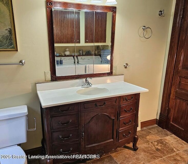 411 Jackson St, Grand Ledge, MI 48837 - bathroom featuring toilet, vanity, and baseboards