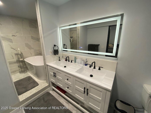11500 Eden Trl, Eagle, MI 48822 - bathroom with a freestanding bath, double vanity, and toilet