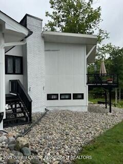 11500 Eden Trl, Eagle, MI 48822 - view of side of property featuring a chimney
