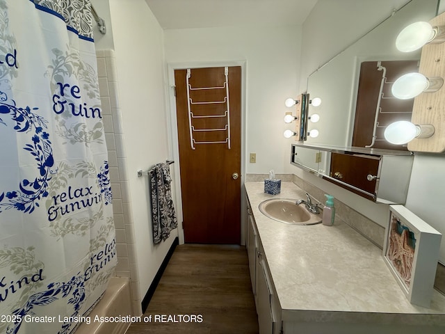 201 W Cavanaugh Rd, Lansing, MI 48910 - bathroom featuring wood finished floors, vanity, and shower / bath combo