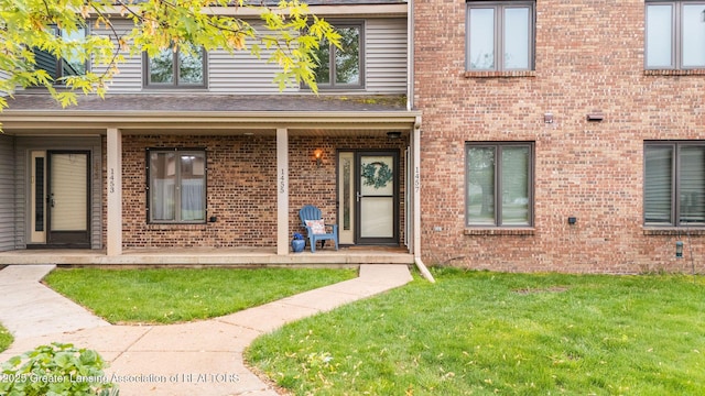 1455 Lakeside Dr, East Lansing, MI 48823 - property entrance with brick siding and a lawn