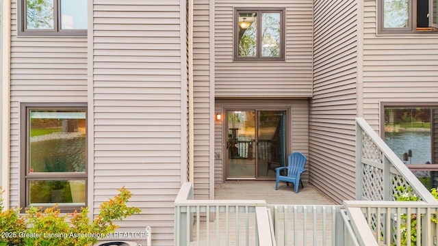 1455 Lakeside Dr, East Lansing, MI 48823 - doorway to property featuring a deck with water view