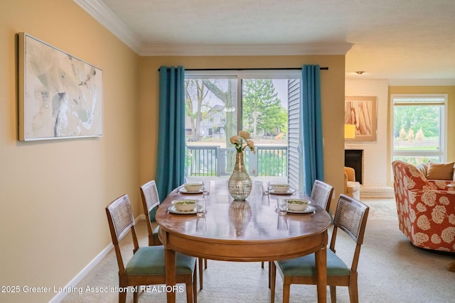 1455 Lakeside Dr, East Lansing, MI 48823 - dining area with carpet floors, crown molding, plenty of natural light, a fireplace, and baseboards
