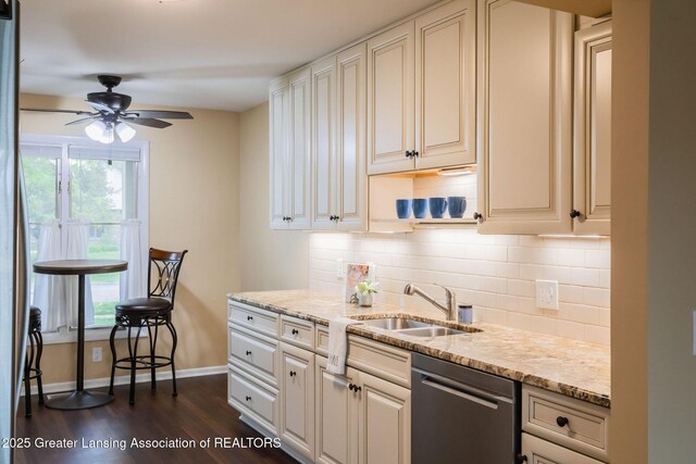 1455 Lakeside Dr, East Lansing, MI 48823 - kitchen featuring stainless steel dishwasher, a sink, baseboards, and healthy amount of natural light