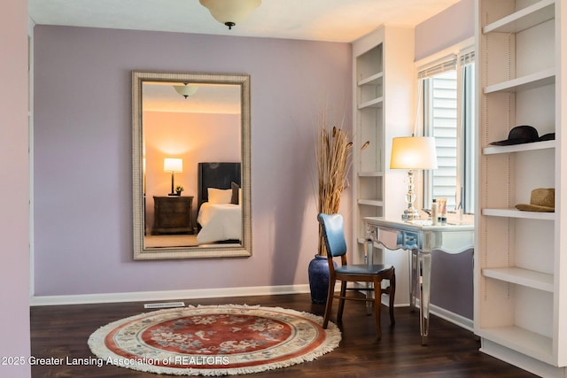 1455 Lakeside Dr, East Lansing, MI 48823 - living area featuring wood finished floors, built in shelves, and baseboards