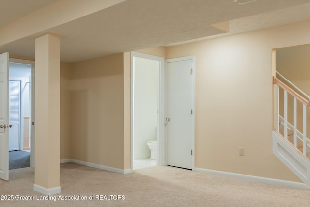1455 Lakeside Dr, East Lansing, MI 48823 - unfurnished bedroom featuring carpet, baseboards, and ensuite bath