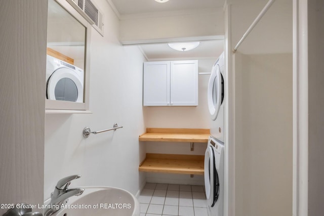 1455 Lakeside Dr, East Lansing, MI 48823 - laundry area with estacked washer and dryer, light tile patterned flooring, and crown molding