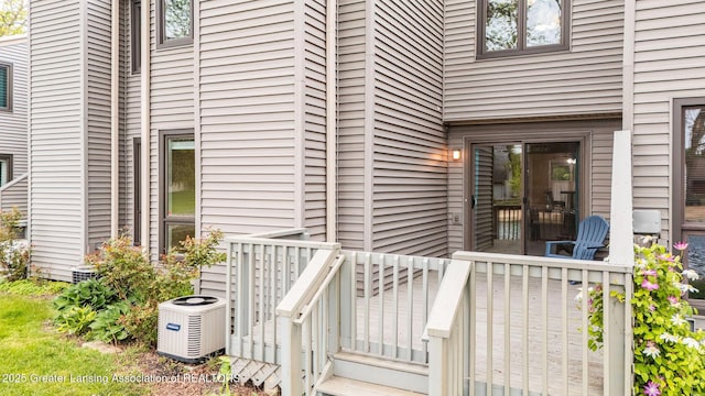 1455 Lakeside Dr, East Lansing, MI 48823 - property entrance with central air condition unit and a wooden deck