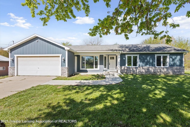 15426 S Lowell Rd, Lansing, MI 48906 - ranch-style house featuring stone siding, a garage, concrete driveway, and a front yard