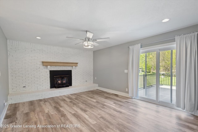 15426 S Lowell Rd, Lansing, MI 48906 - unfurnished living room featuring a ceiling fan, baseboards, wood finished floors, and recessed lighting