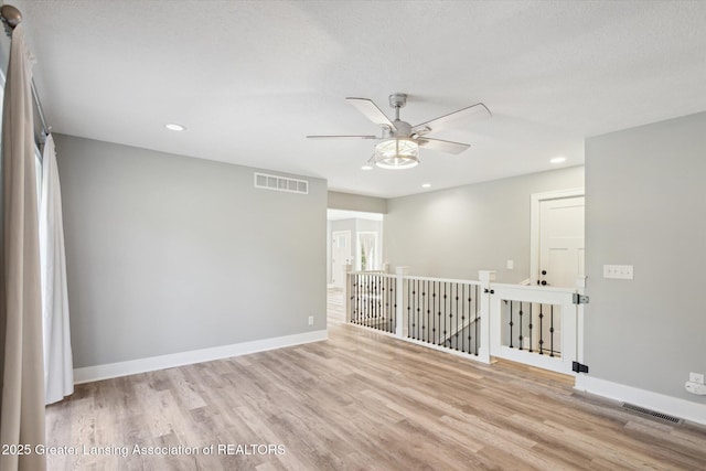 15426 S Lowell Rd, Lansing, MI 48906 - empty room featuring ceiling fan, wood finished floors, baseboards, and recessed lighting