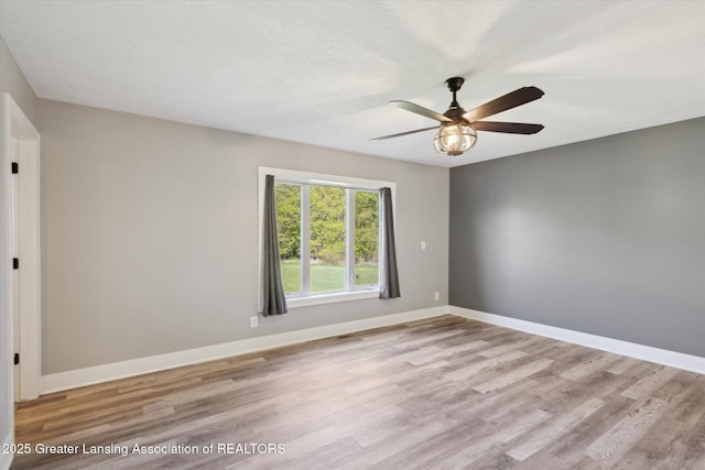 15426 S Lowell Rd, Lansing, MI 48906 - unfurnished room with wood finished floors, ceiling fan, and baseboards