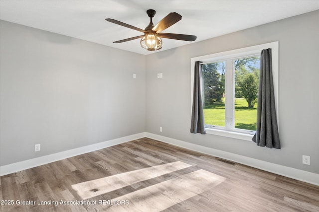 15426 S Lowell Rd, Lansing, MI 48906 - spare room featuring healthy amount of natural light, wood finished floors, baseboards, and ceiling fan