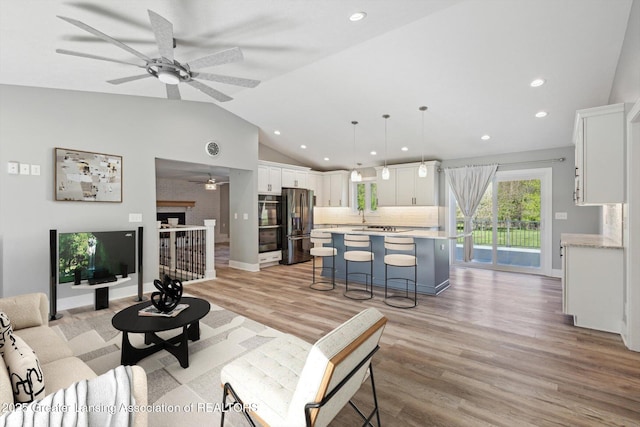 15426 S Lowell Rd, Lansing, MI 48906 - living room with a ceiling fan, vaulted ceiling, light wood-style floors, and recessed lighting