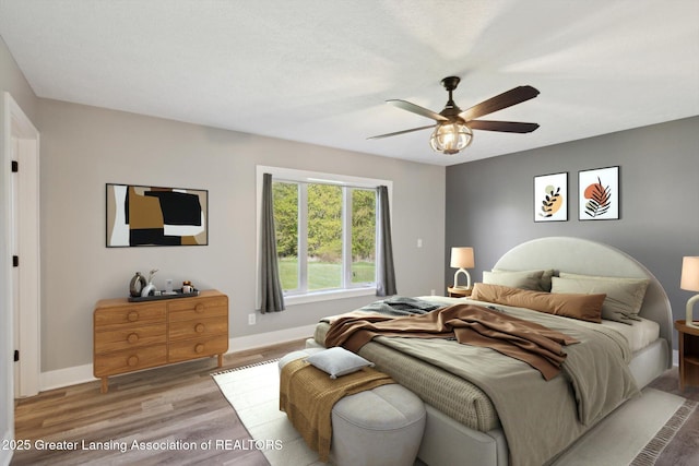15426 S Lowell Rd, Lansing, MI 48906 - bedroom featuring baseboards, wood finished floors, and a ceiling fan
