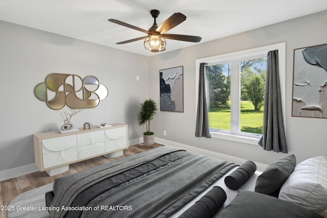 15426 S Lowell Rd, Lansing, MI 48906 - bedroom with baseboards, wood finished floors, and ceiling fan
