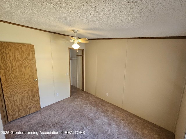 6815 Aurelius Rd, Lansing, MI 48911 - unfurnished bedroom with crown molding, carpet flooring, a decorative wall, a textured ceiling, and a ceiling fan