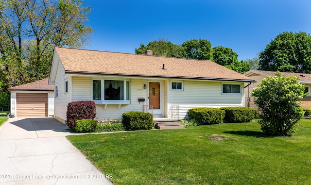 3316 Pickwick Pl, Lansing, MI 48917 - ranch-style home featuring a shingled roof, a front lawn, an outbuilding, a chimney, and a detached garage