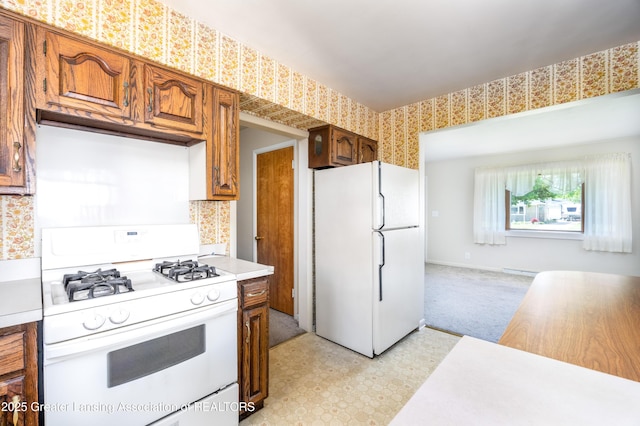 3316 Pickwick Pl, Lansing, MI 48917 - kitchen featuring white appliances, light countertops, brown cabinetry, and backsplash